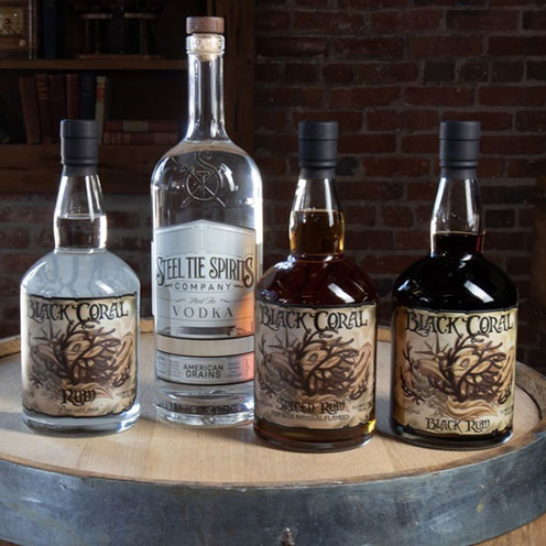 Four bottles of vodka displayed over a barrel. Four bottles of vodka displayed over a barrel.