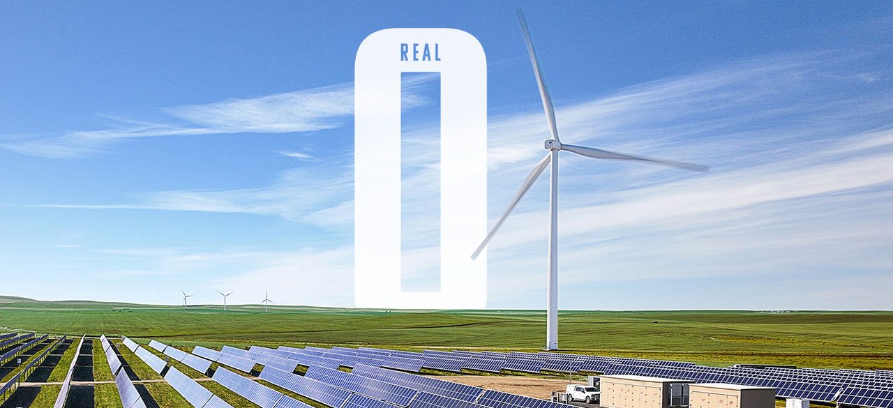 Wind tower behind solar panels