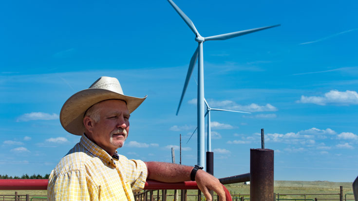 Landowner posing by the wind turbine