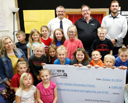 A group of students holding a Center-Stanton Elementary Nextera check