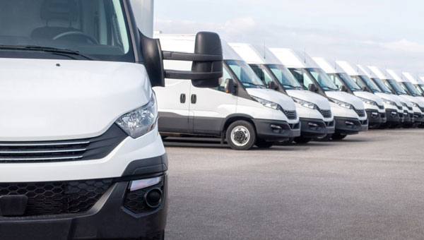 White EV fleet vans parked in a row
