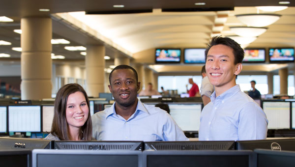 Employees at desks with monitors
