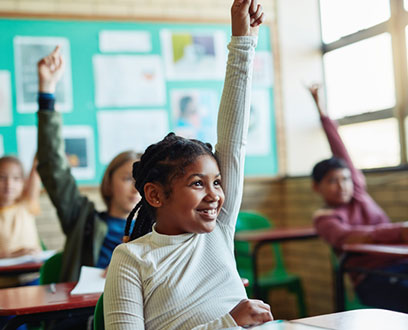 Kids in the classroom raising their hand