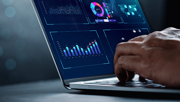 Businessman reviewing analytics data on a laptop Businessman reviewing analytics data on a laptop