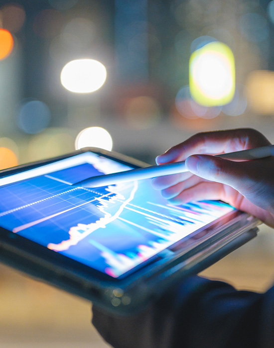 Business woman analyzing graph data on a tablet
