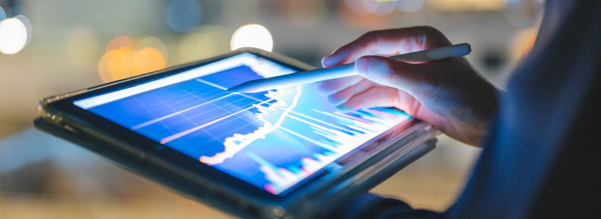 Business woman analyzing graph data on a tablet