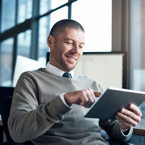 Man reviewing news on tablet Man reviewing news on tablet