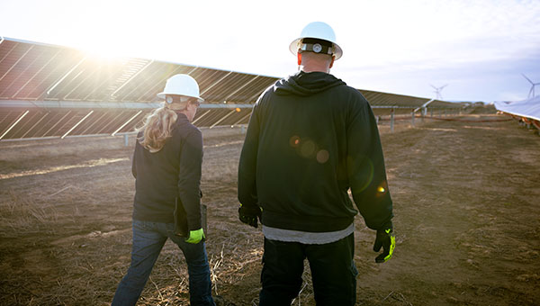 Employees walking through a solar facility