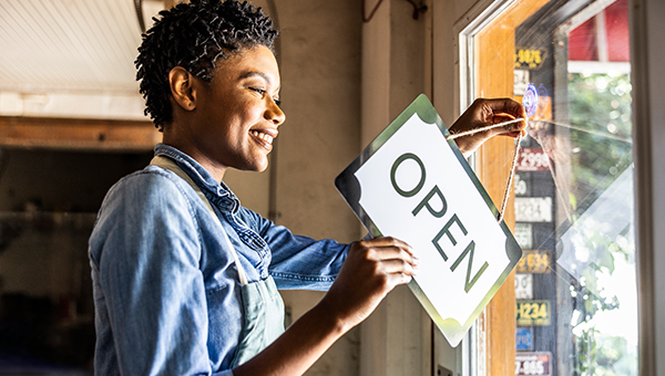 Business owner placing an open sign