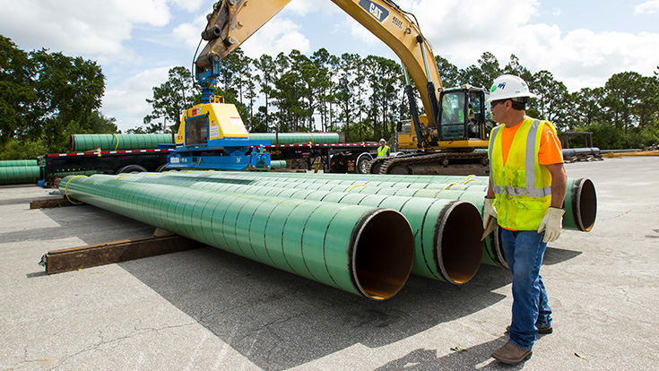 Pipeline Employee wearing safety hat, vest and gloves