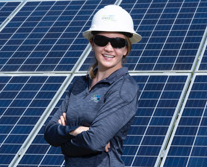 NextEra Energy Resources employee by a solar panel NextEra Energy Resources employee by a solar panel