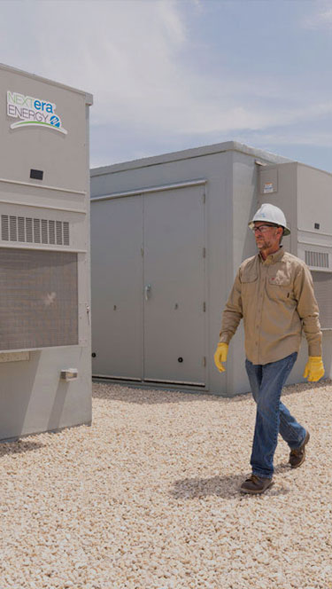 Battery storage employee walking through a battery storage facility