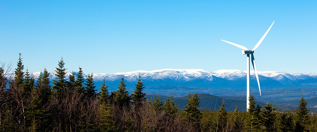 Wind mill overlooking Canadian ice-capped mountains