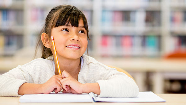 Child sitting at a desk in a classroom