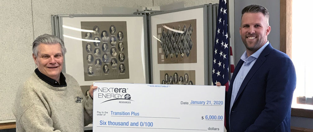 Two Kansas veterans holding up a NextEra check