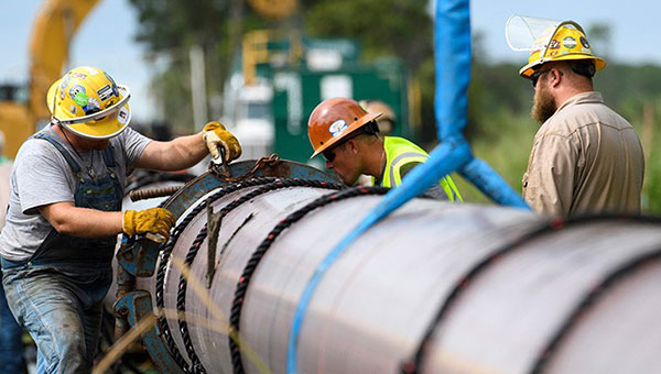 Workers installing a pipeline