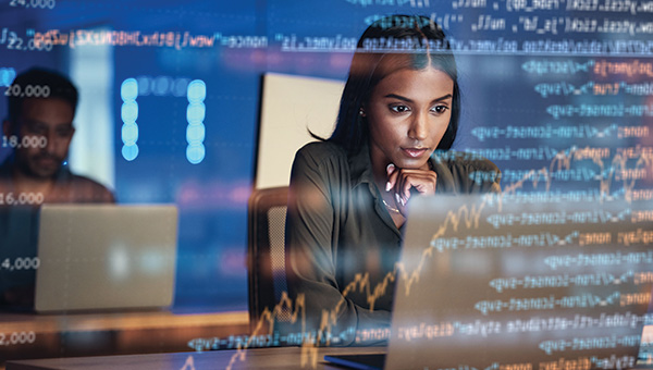 Woman analyzing data on a laptop with data overlays