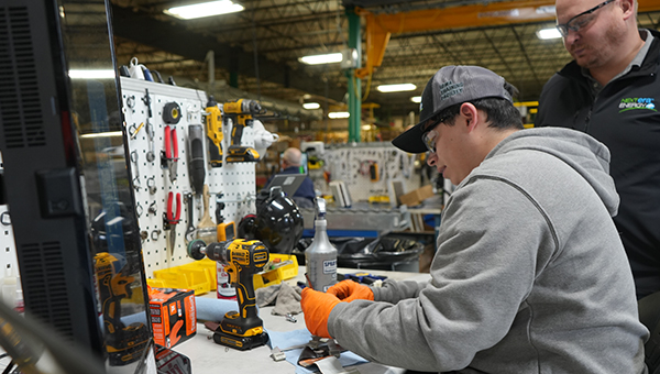 Student being instructed by NextEra Energy Resources employee