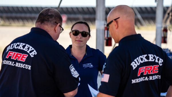 Firefighter seated at the steering wheel of a fire truck