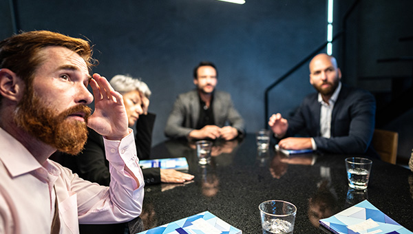 Employees in a stress conference room meeting