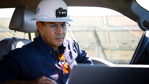 NextEra Energy Resource’s employee in truck looking at laptop