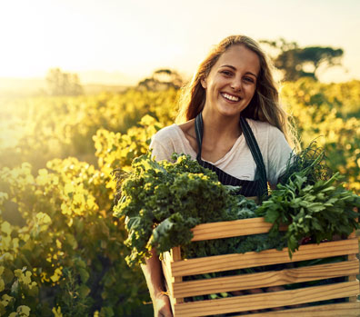 women holding a bucket of vegetables