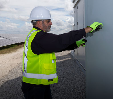 Two NextEra Energy Resources engineers working on an energy storage system.